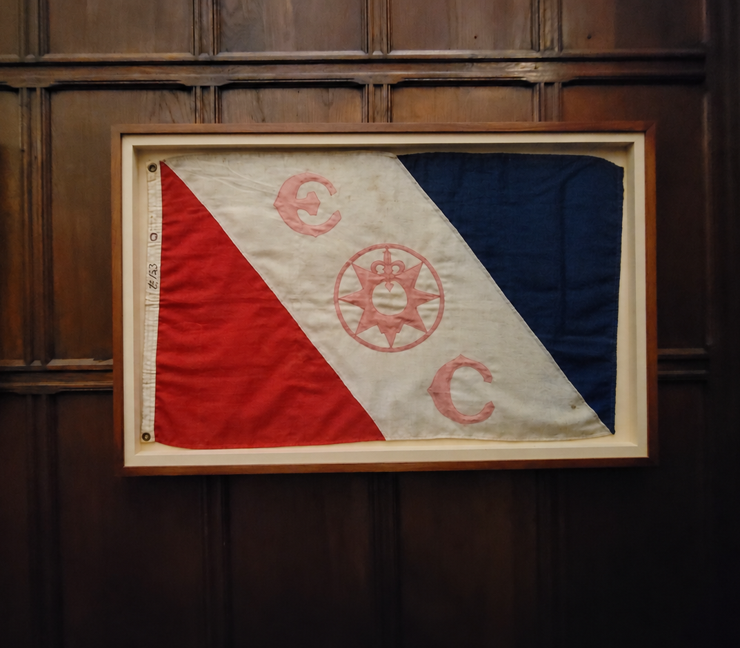 The Explorers Club Flag displayed in a wooden frame
